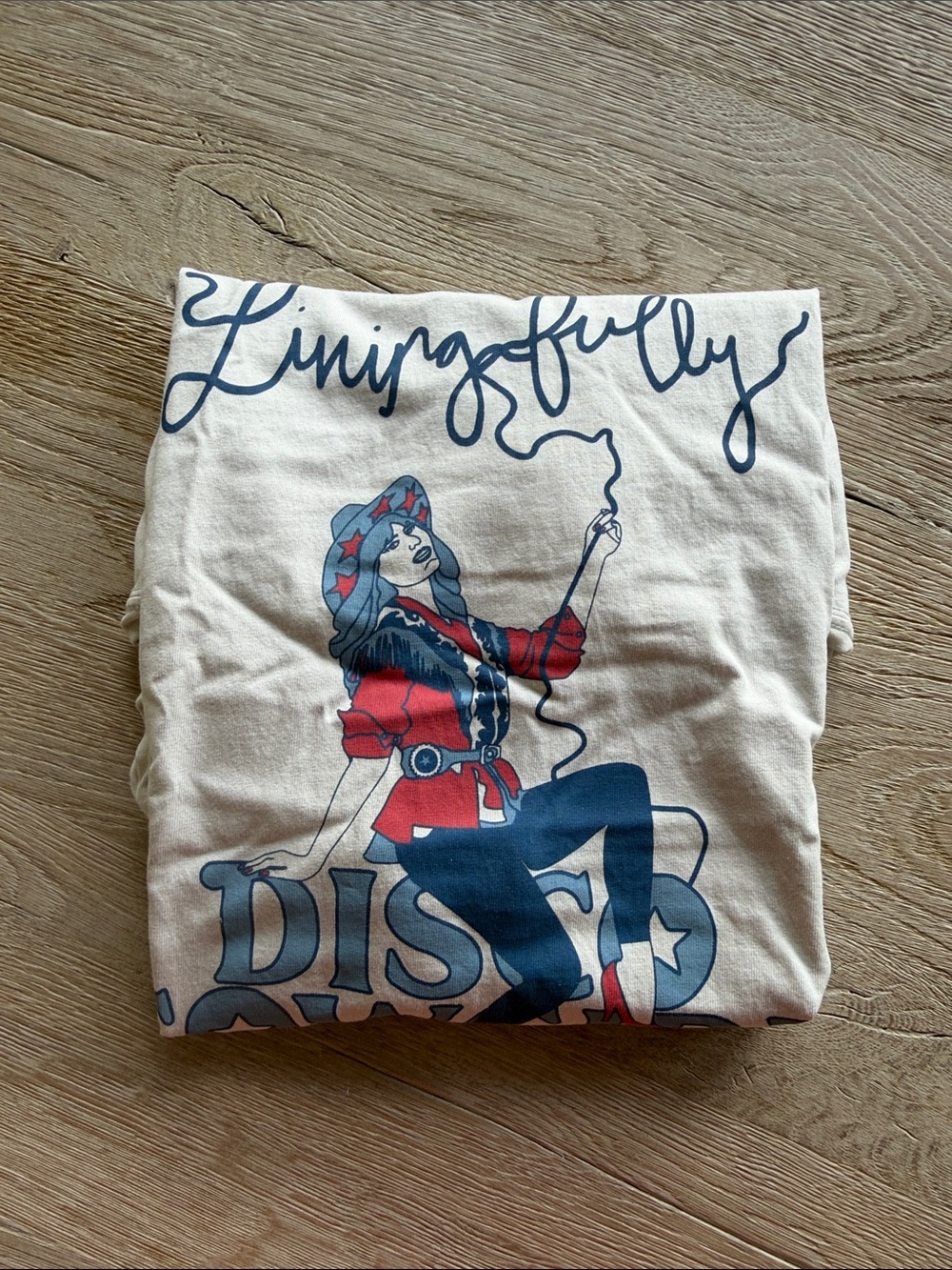 Livingfully Disco Cowgirl Graphic Tee - Cream with Blue & Red Print